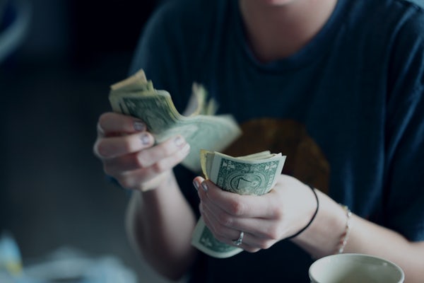 close up photo counting dollar bills